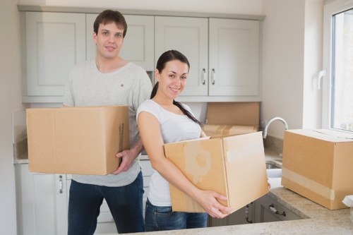 Removal crew protecting floors and doorframes during a move